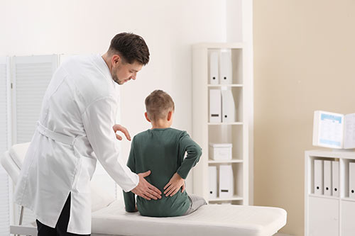 Village Family Clinic - Kid Getting A Chiropractic Adjustment