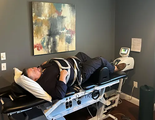 Village Family Clinic - Patient Getting Spinal Decompression Treatment Village Family Clinic - Patient Getting Spinal Decompression Treatment