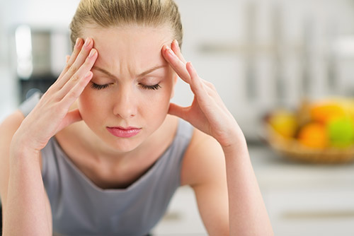 Village Family Clinic - Woman Suffering From Headache